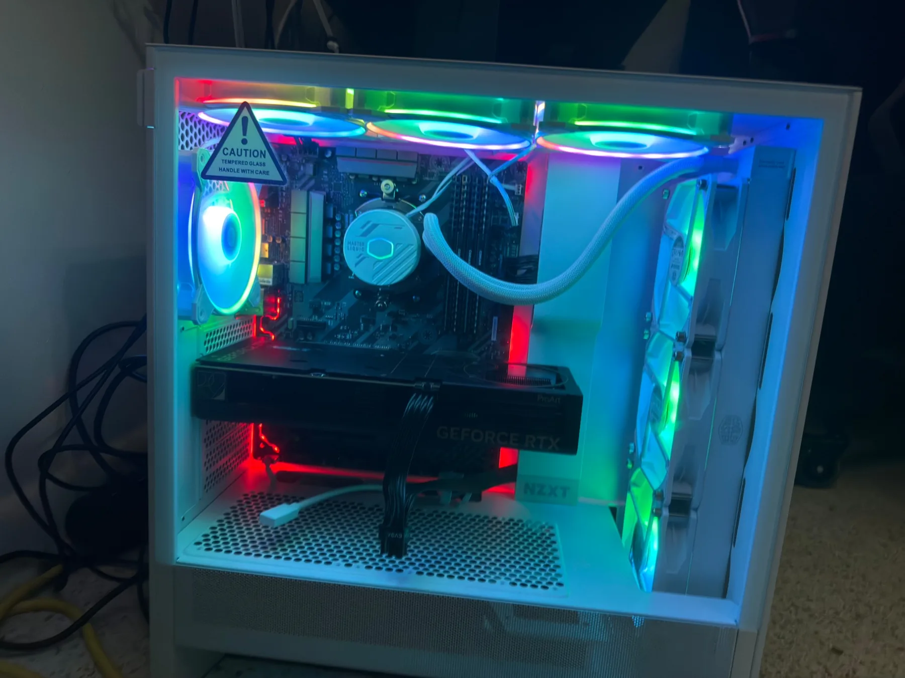 Desktop PC in a white NZXT case lit in cyan and green